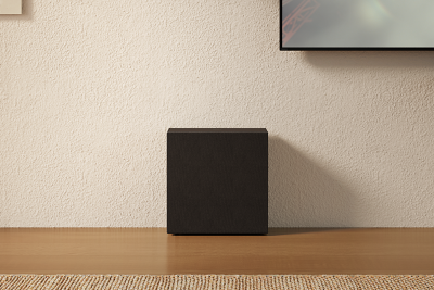 Caisson de basses placé à l'horizontale contre un mur dans un salon