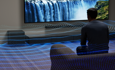 Person seated in front of a TV as visualised bass waves spread through the room