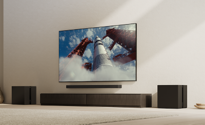 Living room setup with TV, soundbar, and two subwoofers