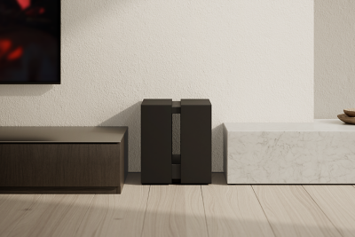 Subwoofer placed beside a TV cabinet against a wall
