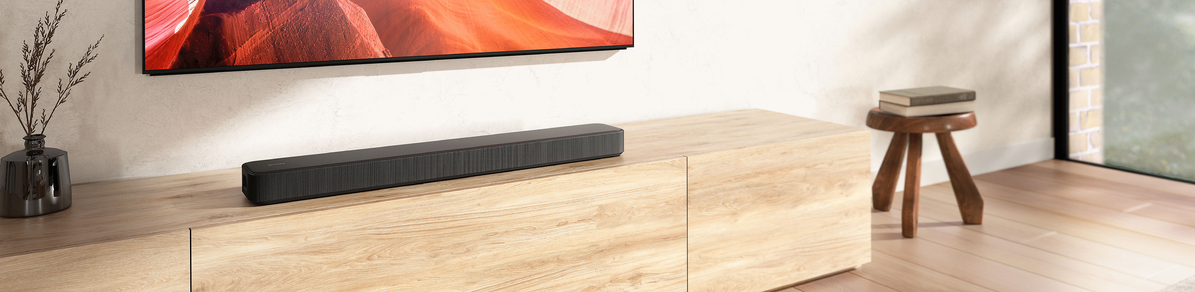 Image of the HT-S2000 sound bar sitting on a wooden TV unit