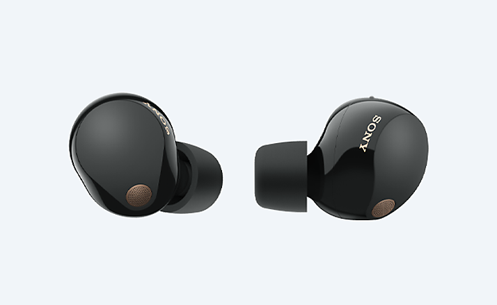 Truly wireless earbuds on gray background