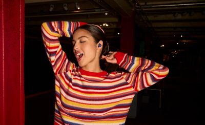 Olivia Rodrigo wearing violet LinkBuds Open headphones