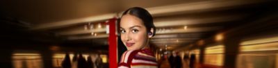 Olivia Rodrigo wearing violet LinkBuds Open headphones