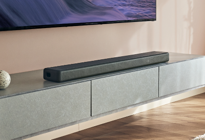 A bright, contemporary living room featuring an HT-A3000 soundbar positioned underneath a wall-mounted BRAVIA TV