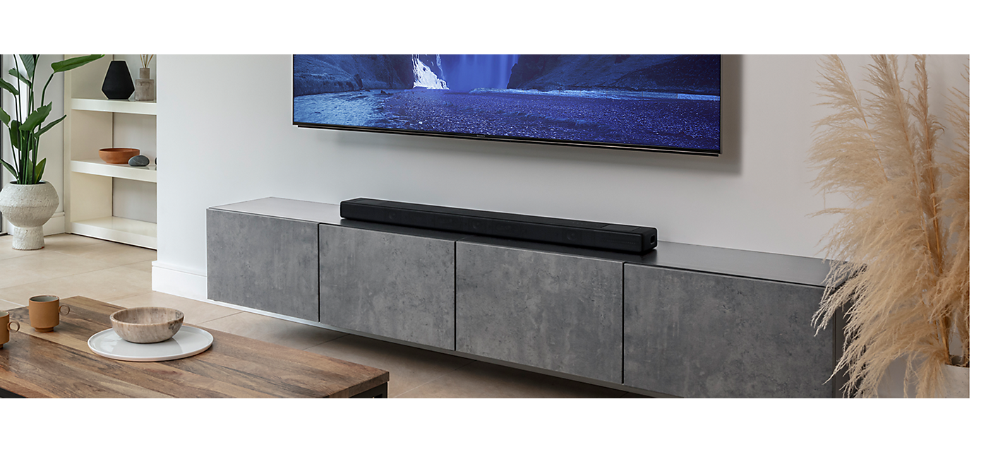 Angled front shot of HT-A5000 in a living room under a BRAVIA TV