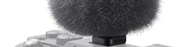 Photo of the ECM-G1connected to the camera and fitted with a fur type jammer for wind protection.