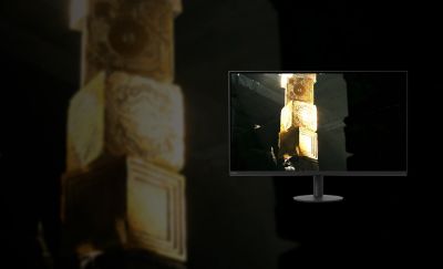 The new M9 II Gaming Monitor displaying a bright graphic of stacked golden cubes on a black background.