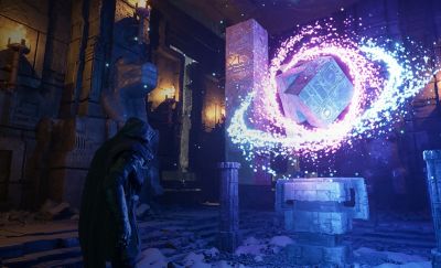 Gameplay footage with a character in the centre looking at a floating magical cube in bright vivid colours.