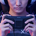 A pro gamer wearing a headset and playing on the Xperia 1 IV Gaming Edition