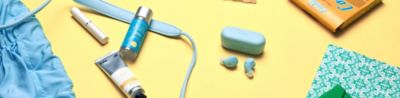 WF-C510 earbuds sat on a table with respective blue earbuds case, with other personal accessories on the table