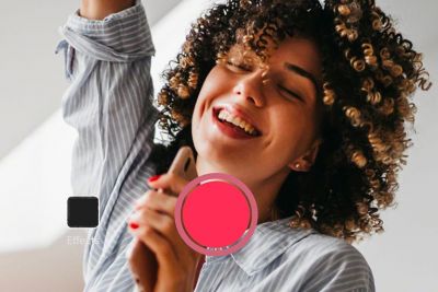 An image of a woman singing into her phone.