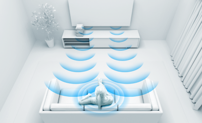 Illustration of woman on a sofa watching TV—blue sound waves are emanating from the TV