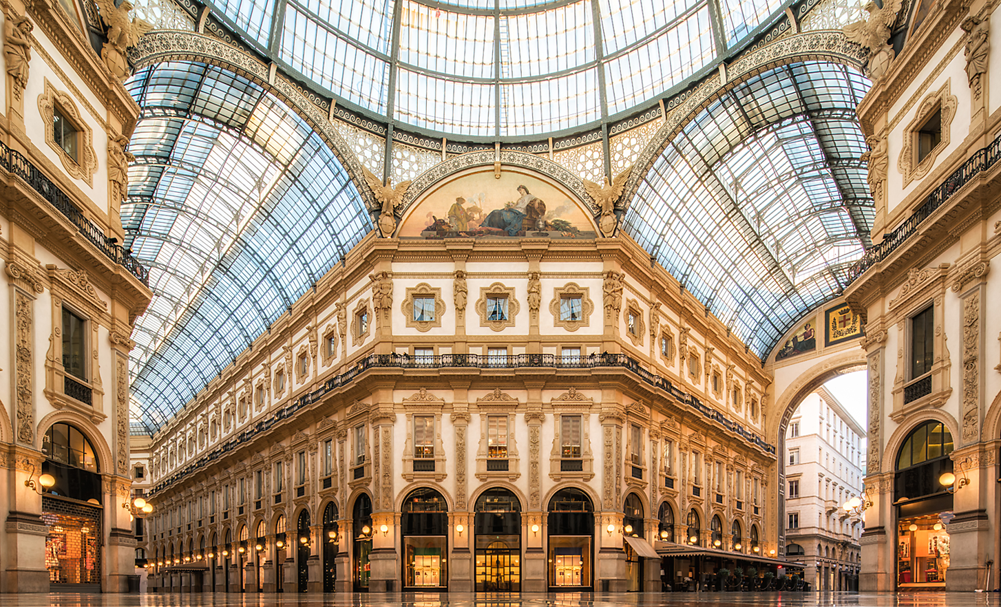 The vast, ornate interior of an old building with glass roof