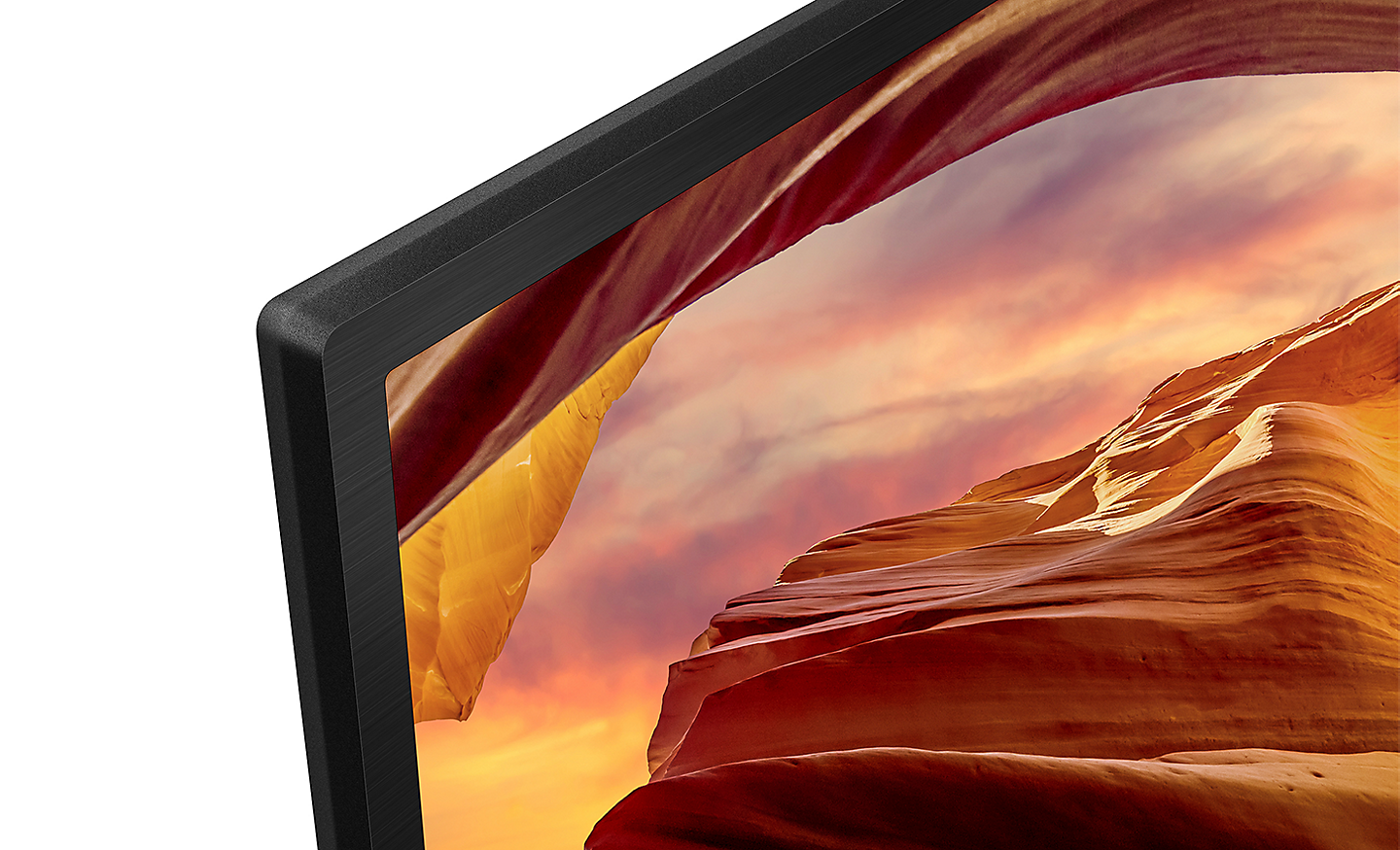 Close-up of the bezel of X64L Series BRAVIA TV with screenshot of rock formations
