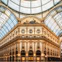 The vast, ornate interior of an old building with glass roof