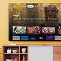 Living room with a wall-mounted BRAVIA TV displaying an array of entertainment apps and streaming services