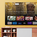 Living room with a wall-mounted BRAVIA TV displaying an array of entertainment apps and streaming services