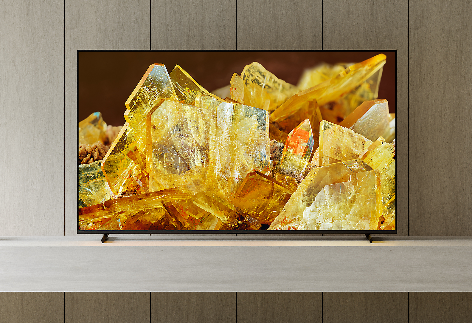 BRAVIA X90L in living room with statues and plant beside TV and golden crystals on screen