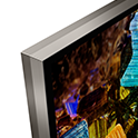 Detail of corner of BRAVIA TV showing virtually frameless Seamless Edge design and screenshot of colourful foil boxes