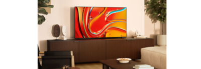 TV on a wooden cabinet with screenshot of red and blue water droplets