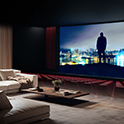 Home cinema setup with a huge screen displaying a person's silhouette and a nighttime city skyline.