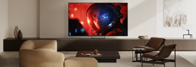 BRAVIA 9 II on its Mirage Stand displaying a vivid scene of an astronaut in a modern living room