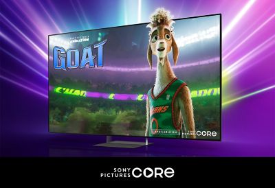 Promotional title card for the Sony Pictures Animation film GOAT on a TV screen, featuring an animated goat basketball player in a green jersey, set against a vibrant purple backdrop. "Available on Sony Pictures Core" branding visible in the bottom right.