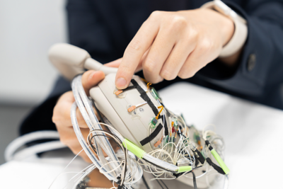 여러 센서와 측정 케이블이 부착된 WH-1000XM6 헤드폰의 테스트 클로즈업