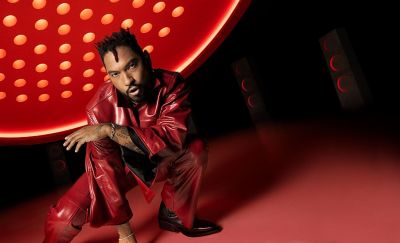 Image of a person crouching under a large red and orange light display