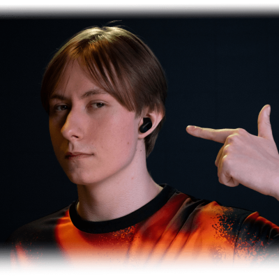 Profile image of Chronicle wearing a pair of black INZONE Buds and pointing to them with his left hand