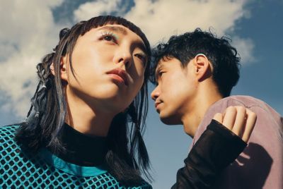An image of Sara Yoshida (left) and Ryuta Tsunoda (right) standing in front of a cloudy sky. 
