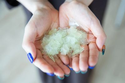 Flaked plastic fragments on the palm of the hands