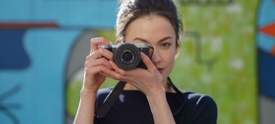 Portrait of woman taking photos outdoors