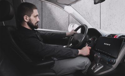 Imagen de un conductor arrancando su auto y el XAV-AX8500 activándose cuando el auto arranca