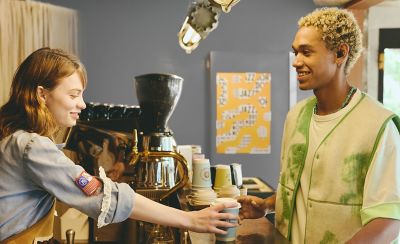 Barista serves a customer a coffee