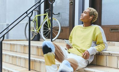 Man sitting relaxing on steps listening to music