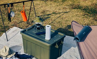 An outdoor camping setup with the ULT FIELD 1 portable speaker providing music.
