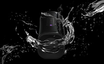The ULT FIELD 1 portable speaker surrounded by water to display the waterproof rating.