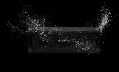 An ULT FIELD 1 portable speaker surrounded by water to display the waterproof rating.