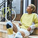 Man sitting relaxing on steps listening to music