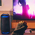 Image of the SRS-XV800 next to a TV with a music concert on screen