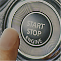 Image of a car ignition button and a finger pressing it