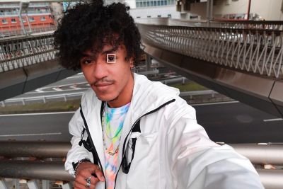 Selfie on a pedestrian bridge, eyes in focus.