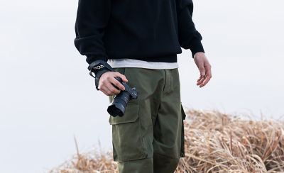 Image of man carrying camera in hand