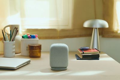 A white LinkBuds Open speaker on a desk.