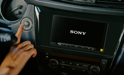 Interior of a car showing the XAV-9000ES screen starting up immediately after ignition, displaying the Sony logo.