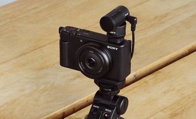 Image showing a user selfie shooting with the camera and shooting grip, using the ECM-W2BT wireless microphone