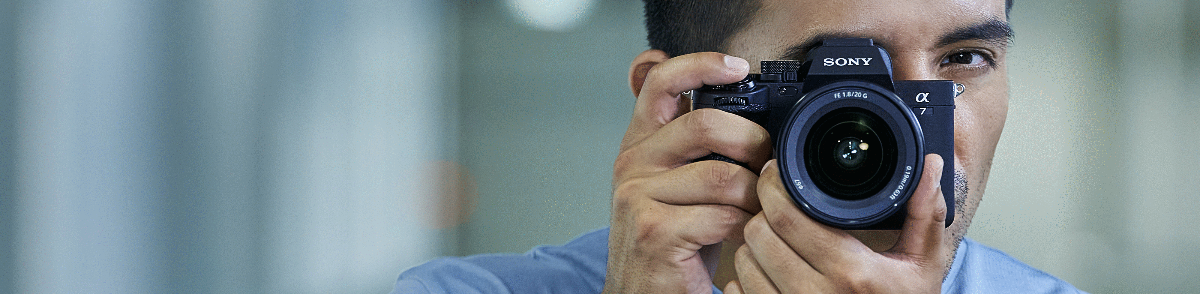 Photo of a photographer looking through the viewfinder while shooting still photos