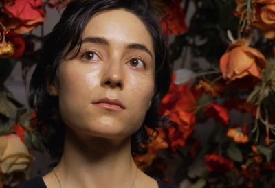Image of a woman with flowers in the background